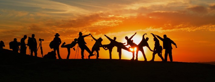 sunset with shadows of a group of people in front